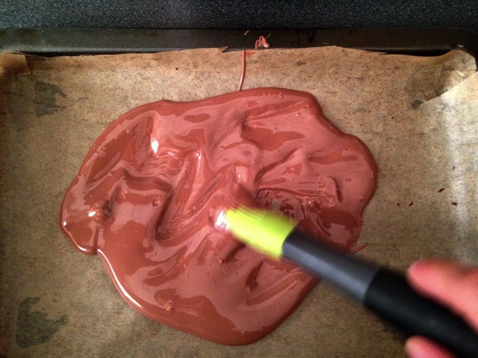 Pour a 1/3 of the chocolate into the smaller lined tray / silicone mould and paint an even thin layer using a pastry brush. Add more chocolate if necessary.