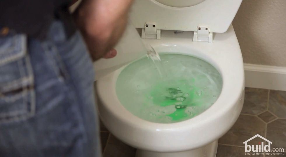 Pour a bucket or pitcher of hot water directly into the bowl. The soap will slowly work it's way through the trapway, then free your clog.