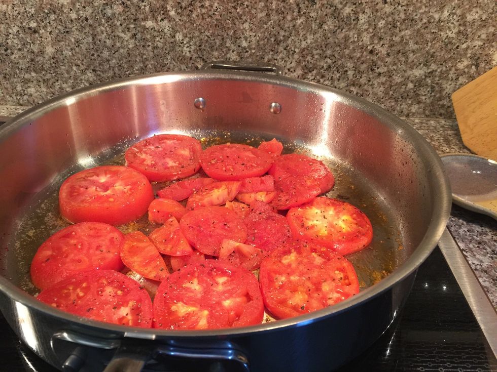 Pour a couple of turns of olive oil into the hot the saut\u00e9 pan. Add the tomatoes in a single layer.