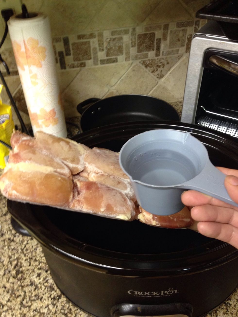 Pour a cup of water in the crockpot to keep the chicken moist