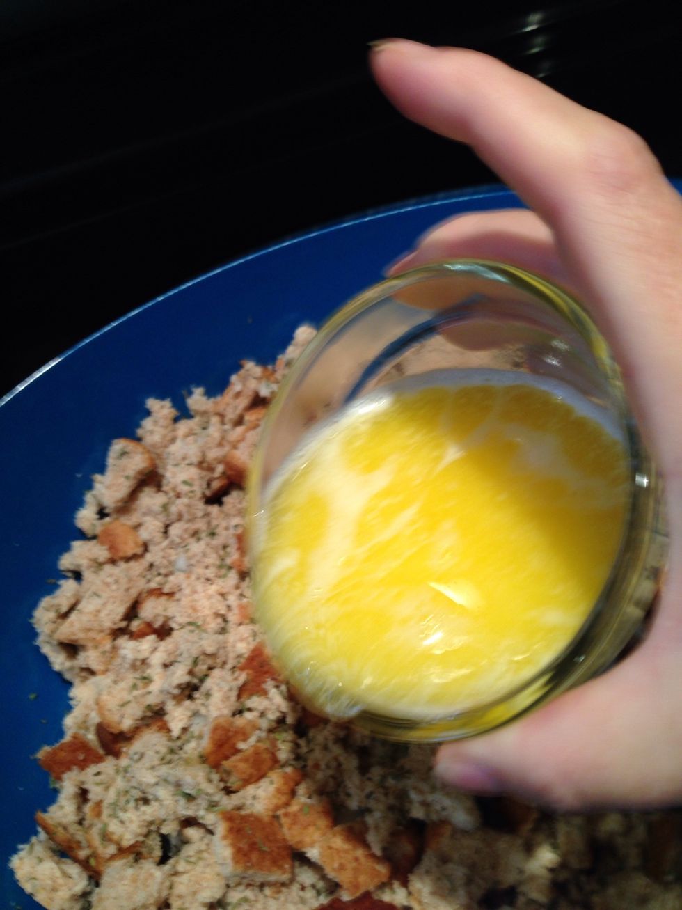 Pour a little bit of the liquids into the dry ingredients. Mix it through with your hands. Keep adding until the mixture is damp.