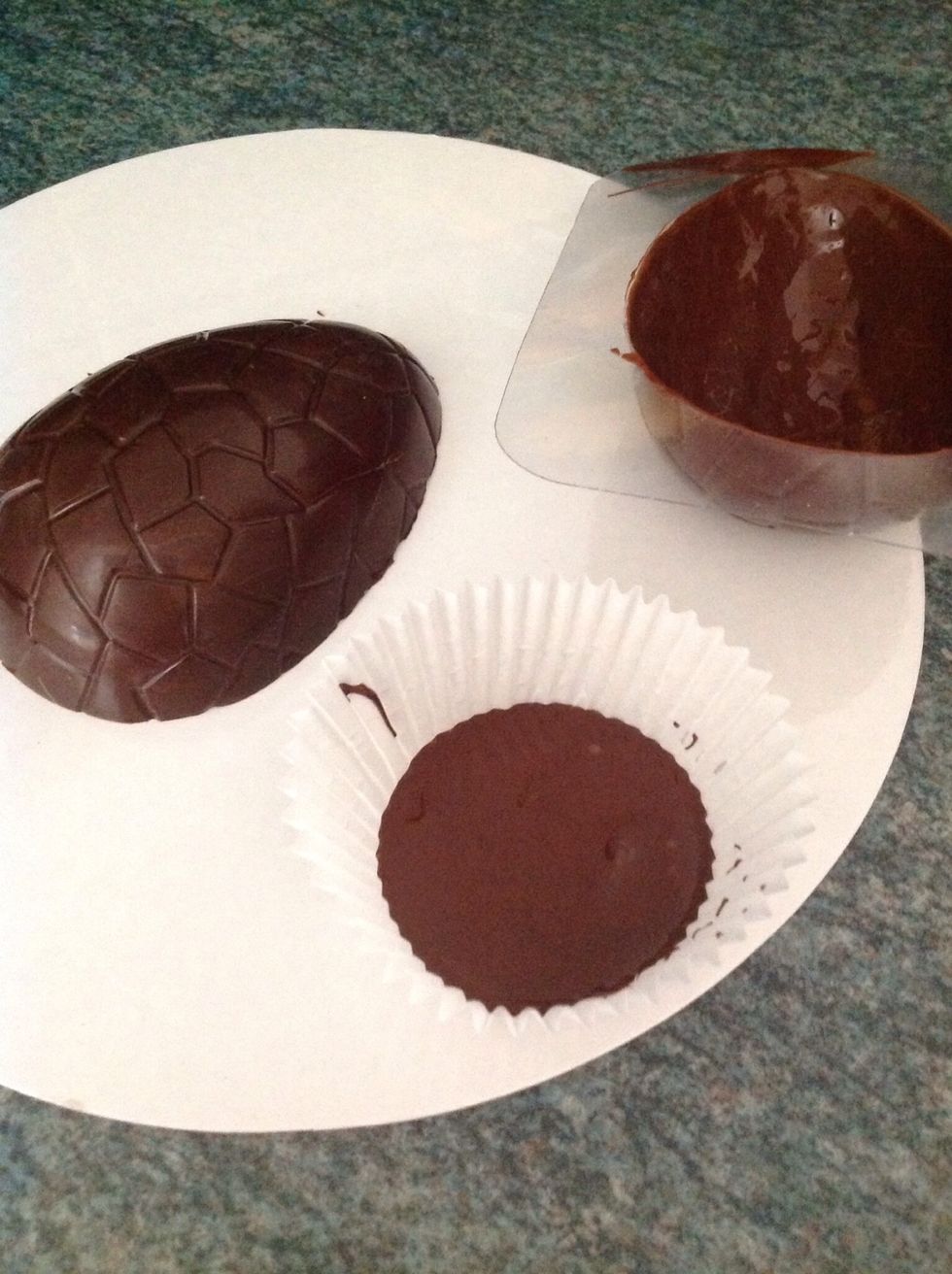 Pour a little melted chocolate in to a cupcake/muffin case, this will form the base of your chocolate egg, allow to set