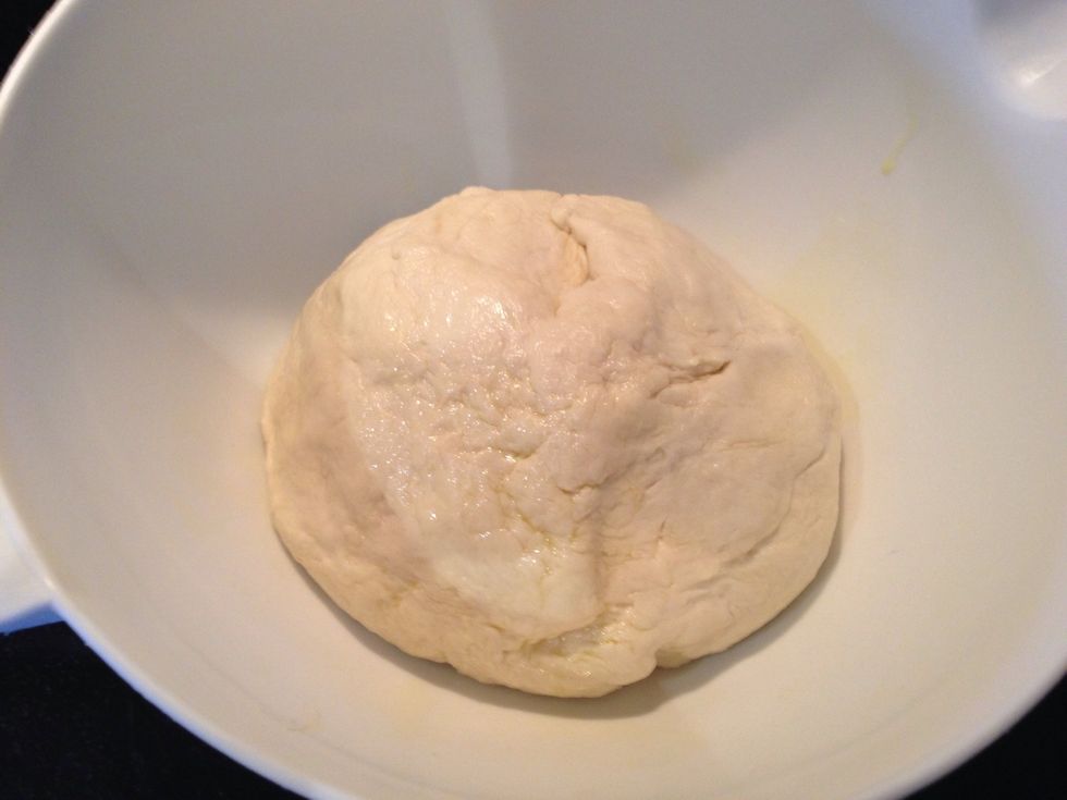 Pour a little olive oil into a bowl. Take the dough and form a ball. Put in bowl and turn to coat. Cover bowl with a clean dish towel. Let it sit for an hour.