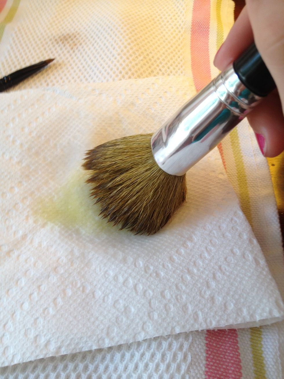 Pour a small amount of olive oil on your paper towel and gently rub the brush around.