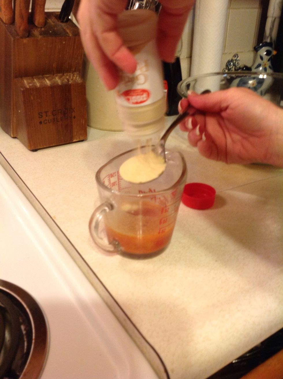 Pour a tablespoon of garlic powder into the butter and hot sauce