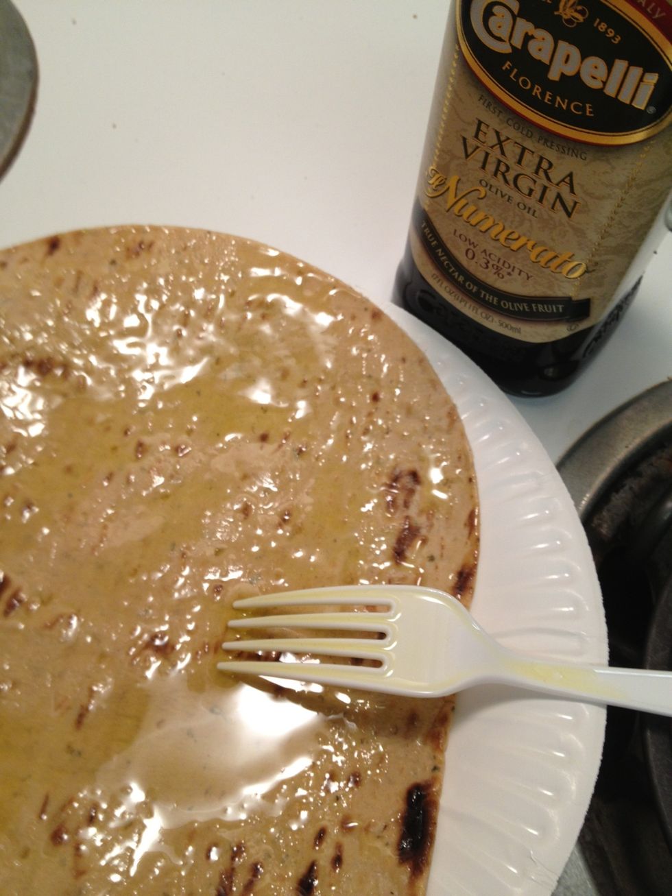 Pour a tbsp of Olive oil on a Flatout flatbread and spread around. I used way too much in this picture so don't go according to this picture