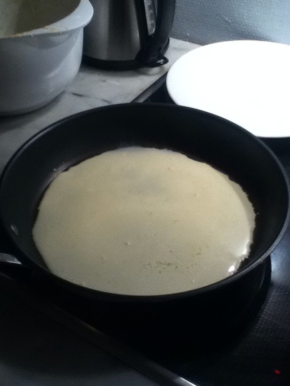 Pour a thin layer of batter into the pan.
