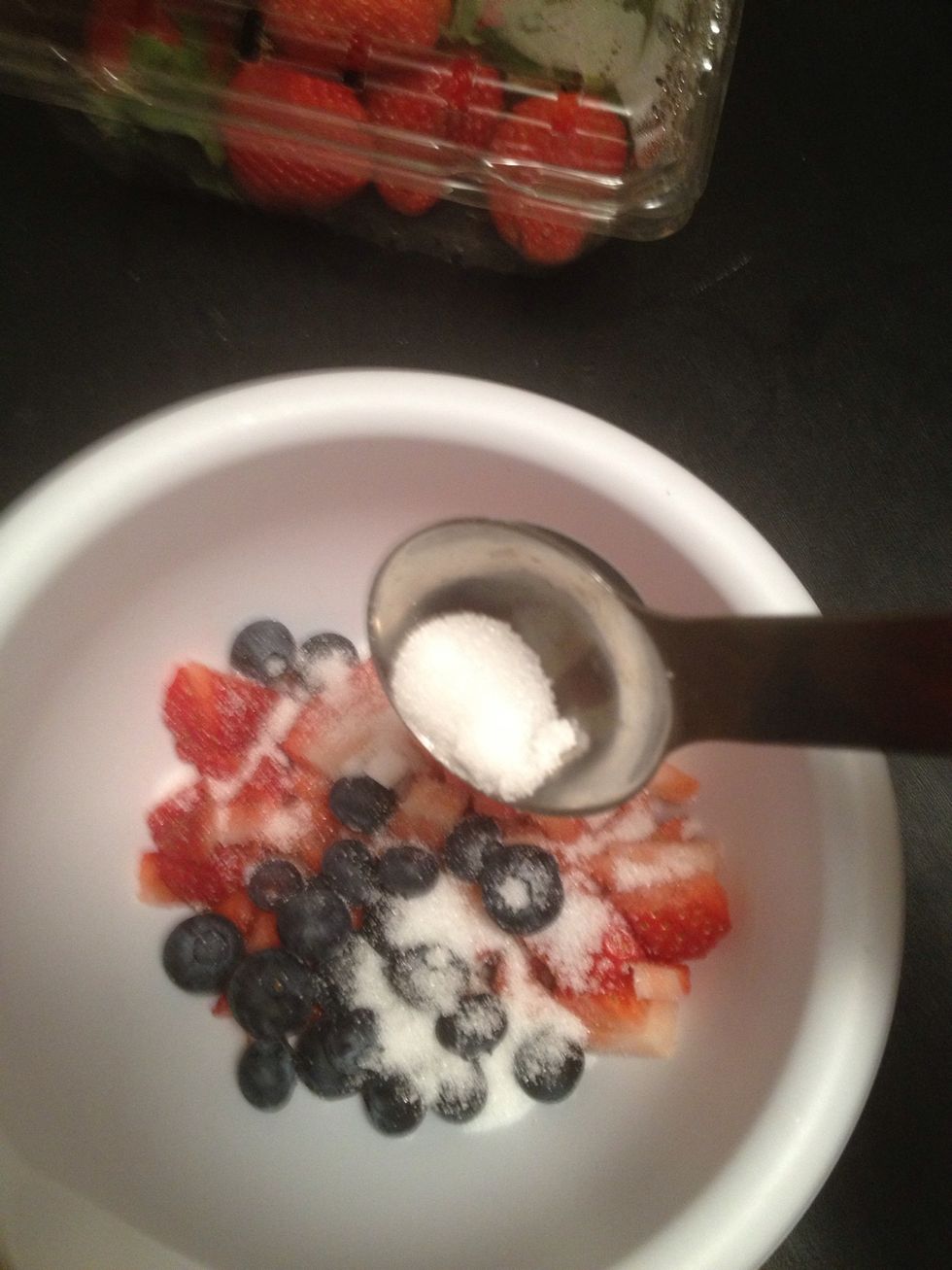 Pour about a tablespoon of sugar over the berries. Leave this in the fridge for as long as possible. I lasted about an hour before I got impatient. Ideally you want to wait several to get a good syrup