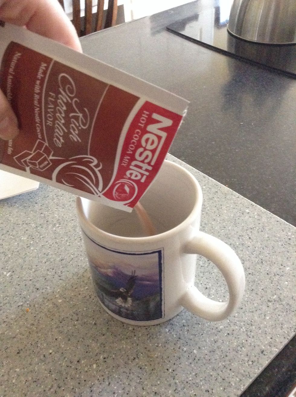 Pour all of your mix into your mug. I use Nestle hot chocolate mix.