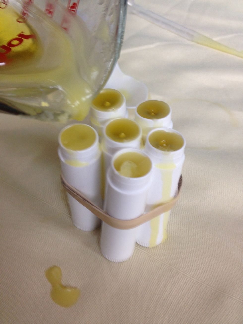 Pour balm base into tubes, filling them almost to the top. Allow them to cool completely. Return excess balm base to the microwave at 30 second intervals until melted, and use to top off your tubes.