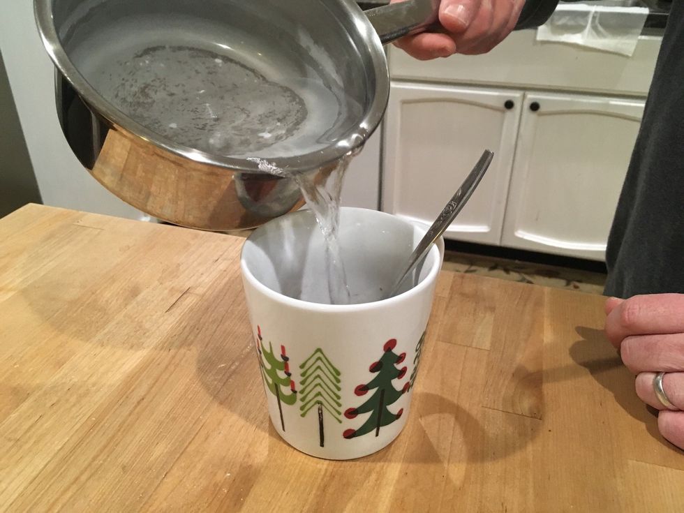 Pour barely any water into the cup and mix