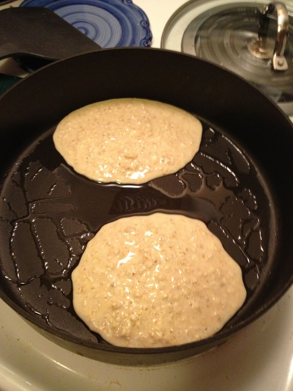 Pour batter by 1/4 cupfuls onto a heated griddle or non-stick pan coated with cooking spray or canola oil. Cook until bubbles appear on the top & turn.