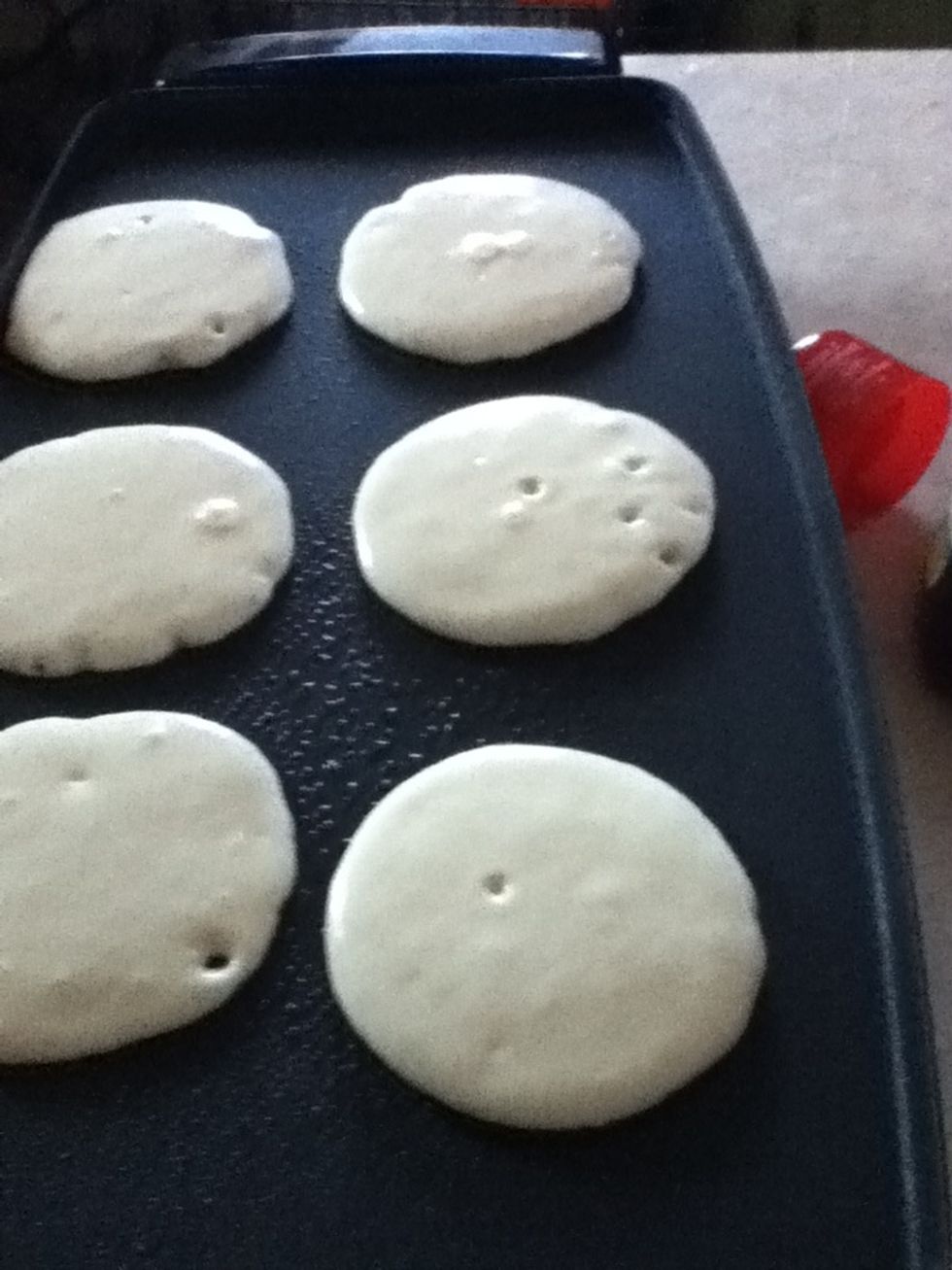 Pour batter onto surface and wait for some bubbles.