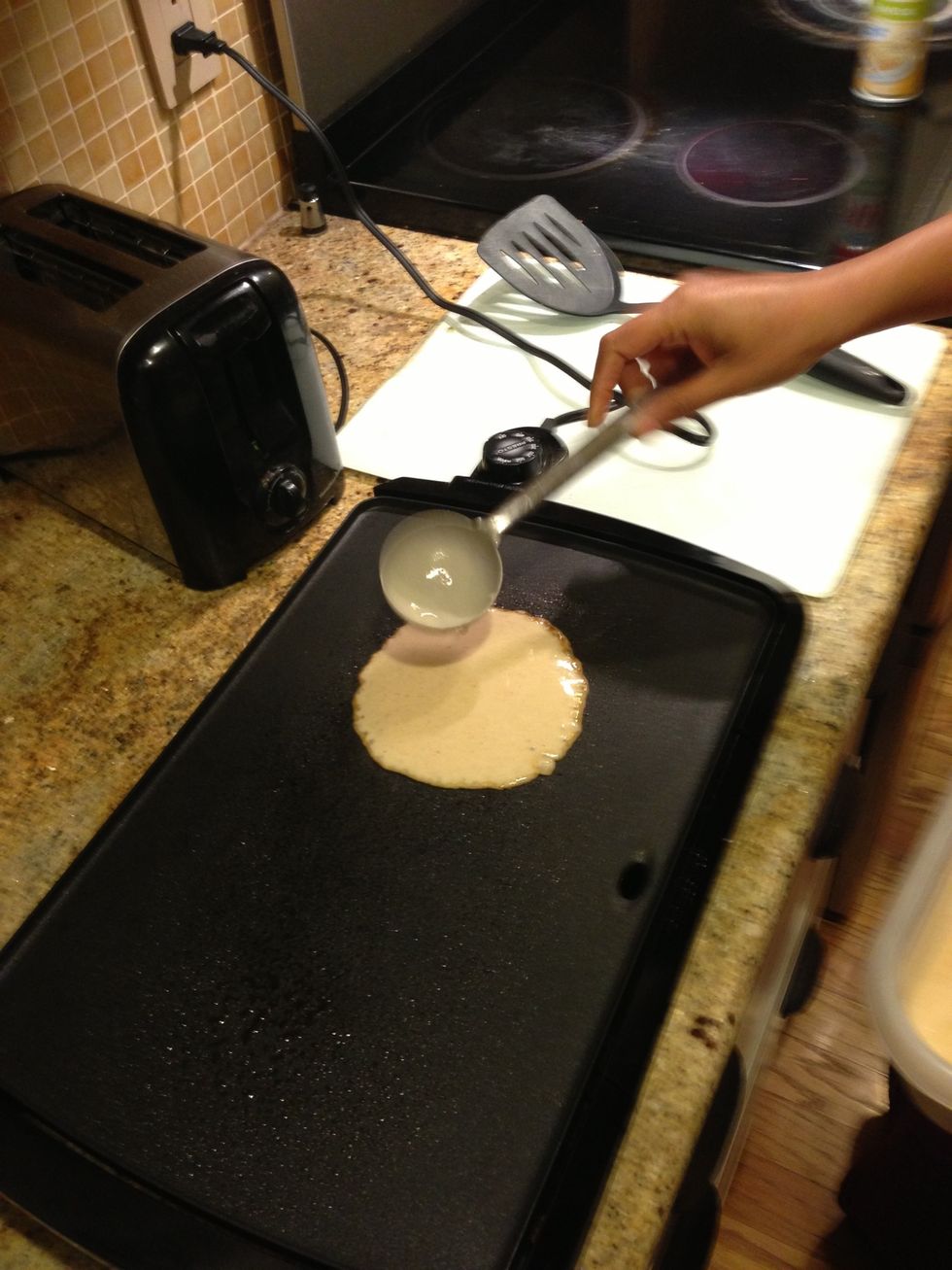 Pour batter onto the griddle using a ladle. Immediately use the back of ladle and spread the batter in circular motion from the center towards the end making the batter spread thinner.