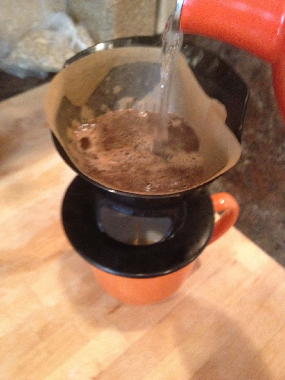 Pour boiled water over grounds