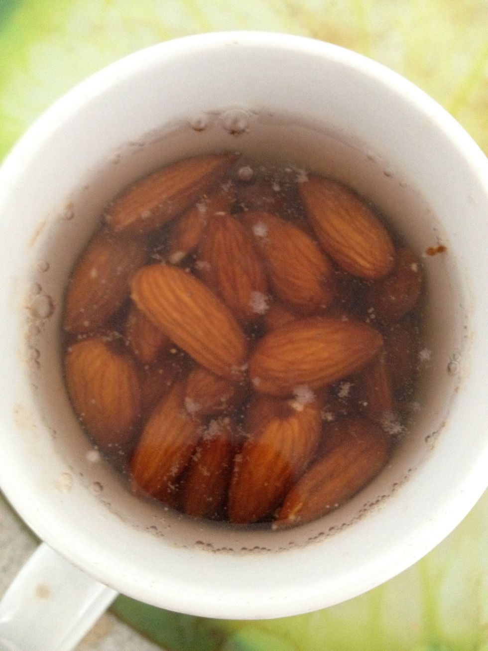 Pour boiling water over the almonds.