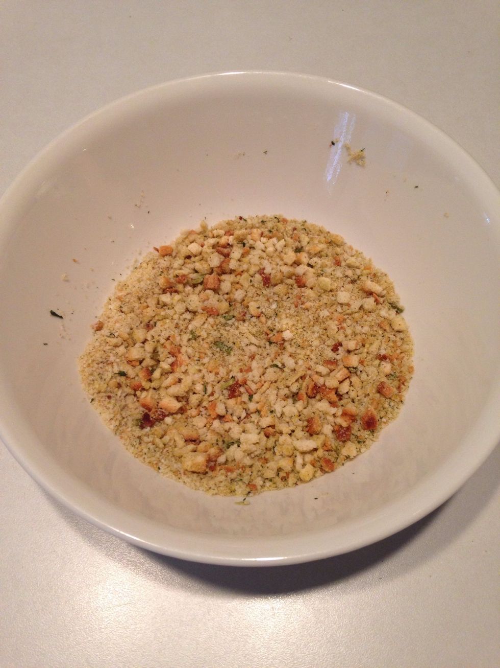 Pour bread crumbs in a shallow mixing bowl.