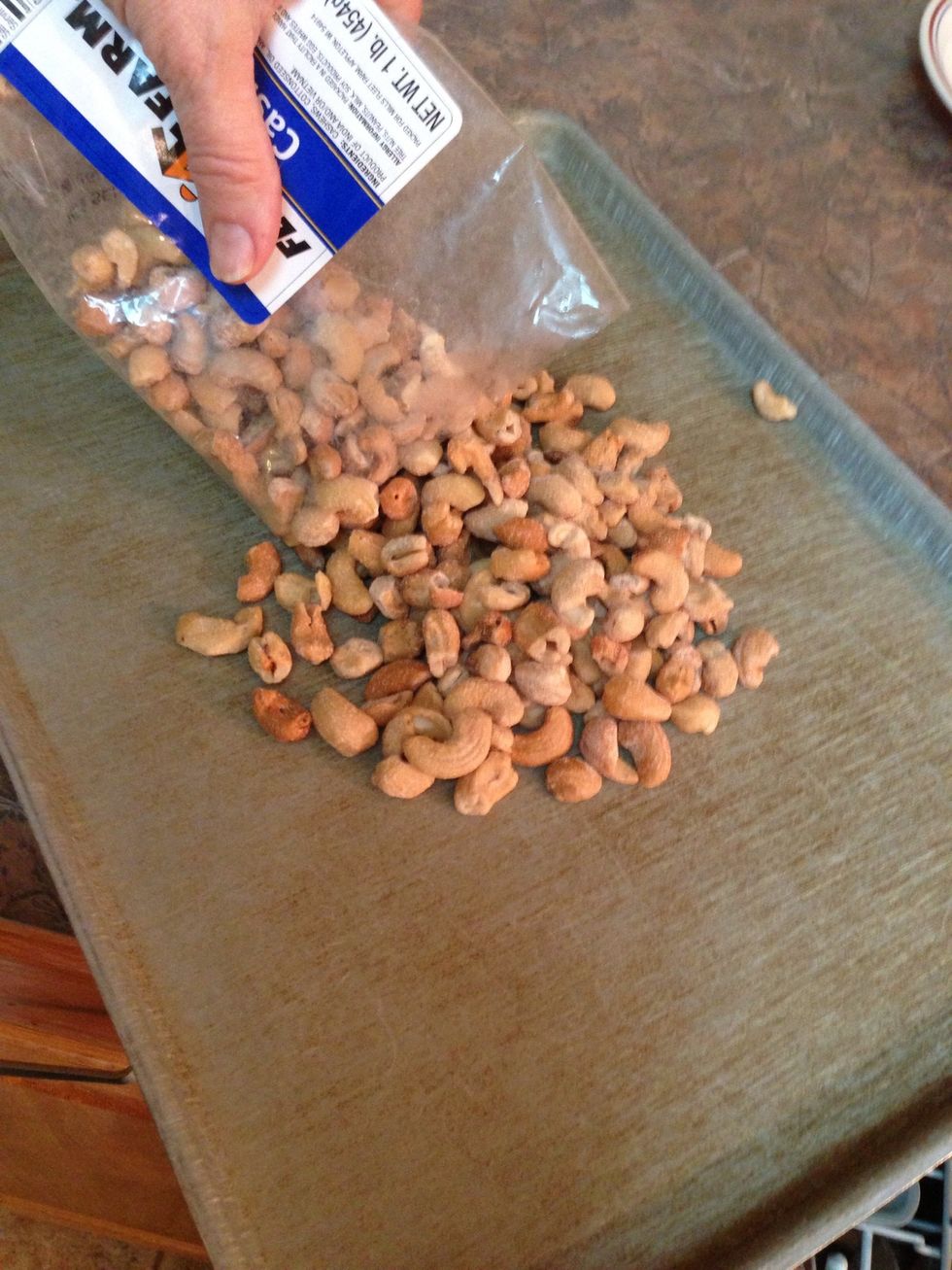 Pour cashews out onto sheet pan. Spread out evenly.