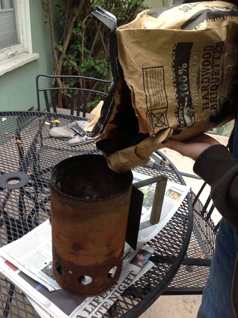 Pour charcoal into top of chimney