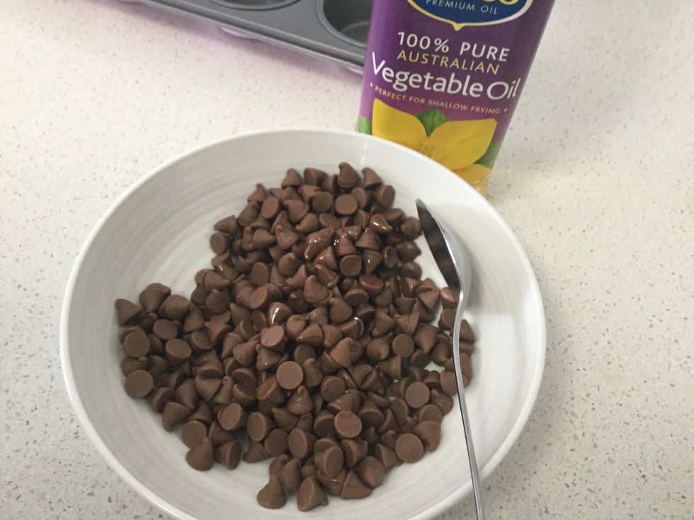 Pour chocolate chips in bowl. Then add a small drizzle of oil.