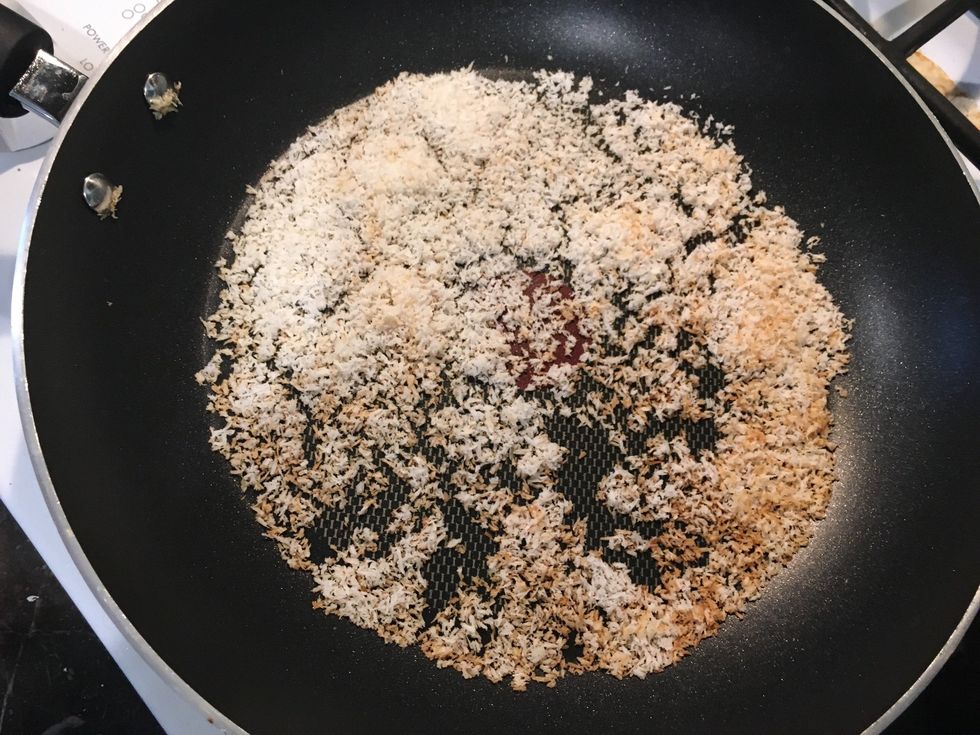 Pour coconut it a pan a continuously stir it around. When it is lightly browned, take it out and pour it in a bowl.