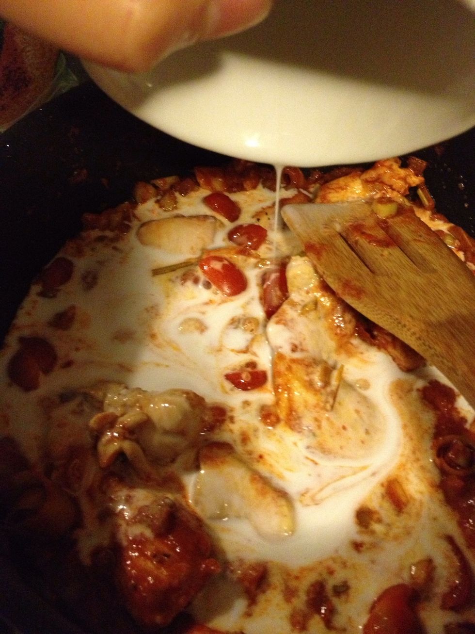 Pour coconut milk into the pot and add eggplants or other vegetable.