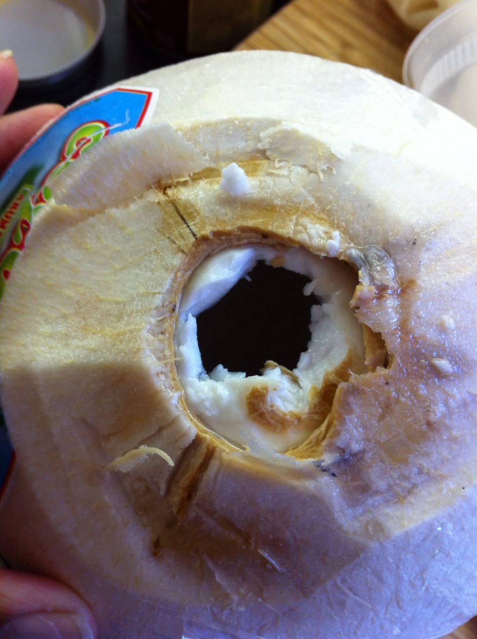 Pour coconut water in with almonds. Scrape out young coconut meat and add to nuts. Note: I use a hammer & screw driver to open coconut.