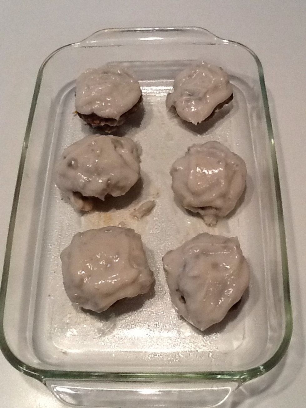 Pour condensed cream of mushroom soup over patties.