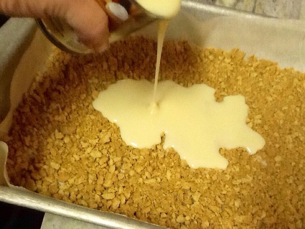 Pour condensed milk over graham crackers.