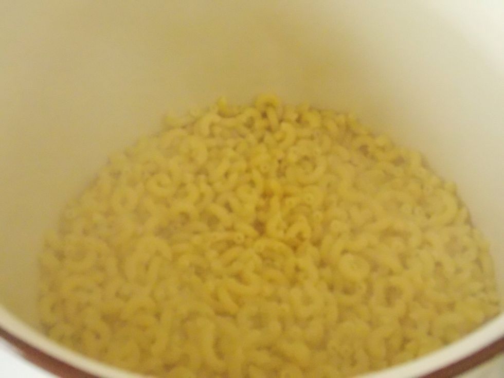 Pour cooked macaroni in large bowl.