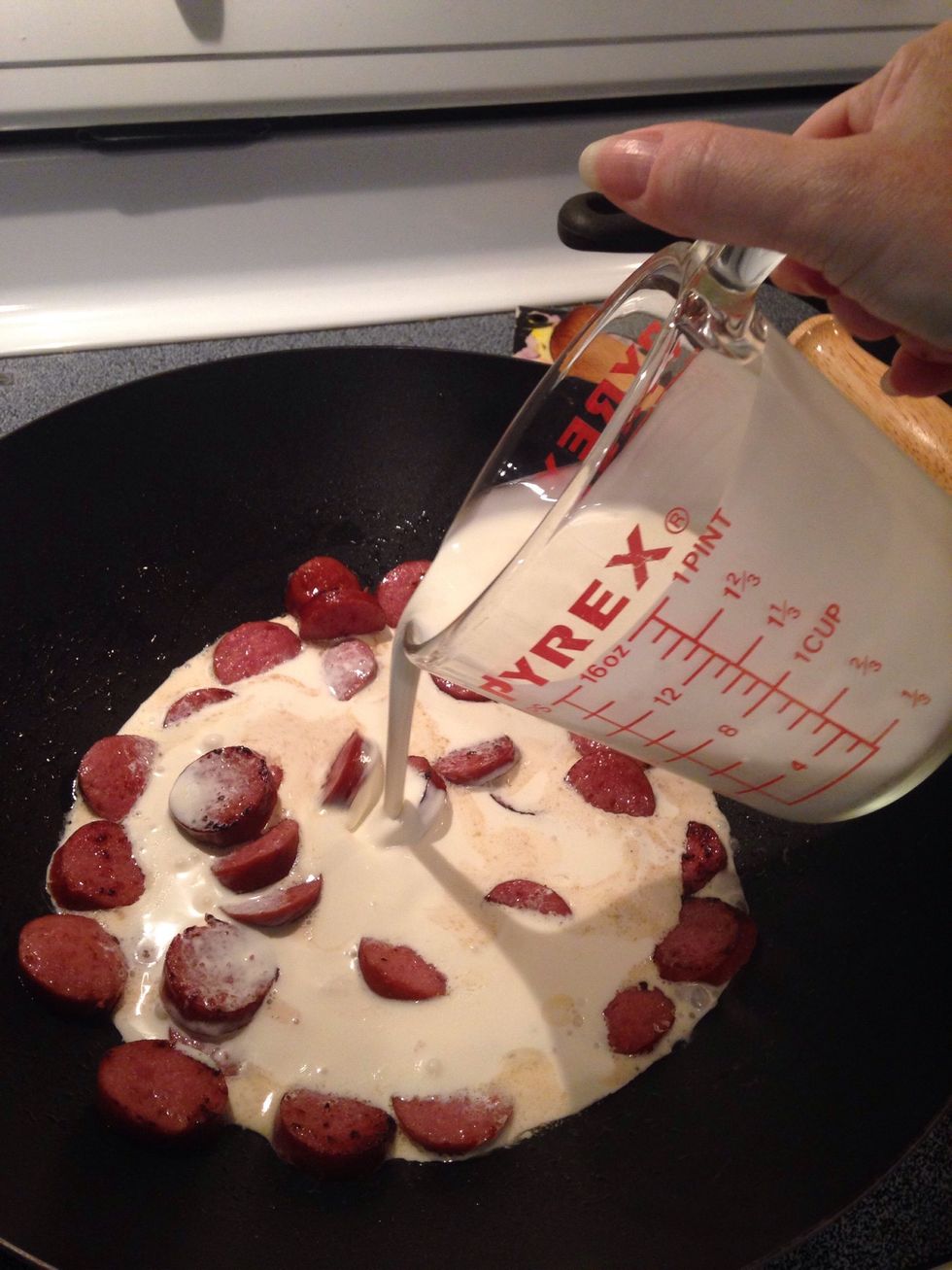 Pour cream over meat.