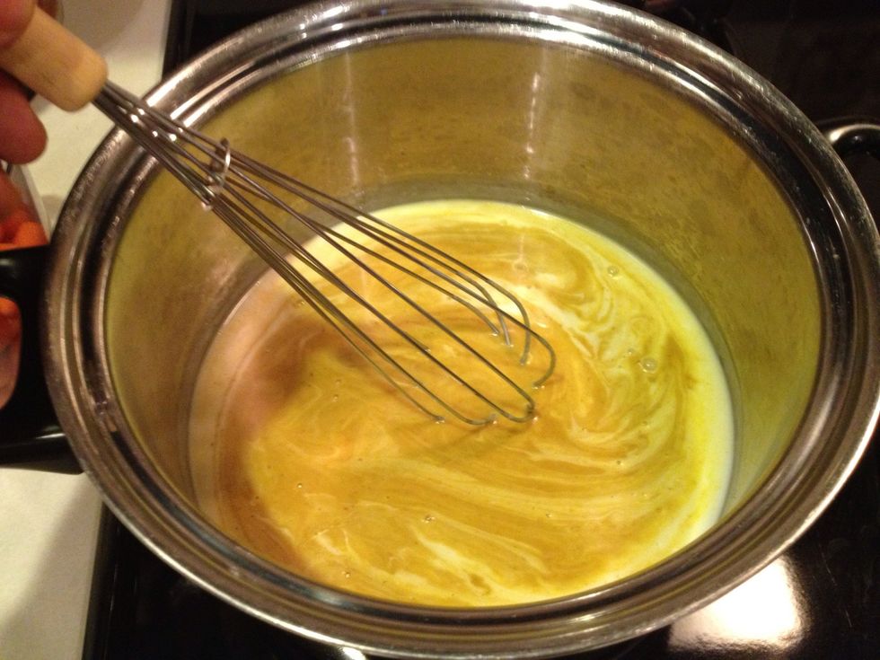 Pour curry and coconut milk into medium-sized saucepan. Stir to combine