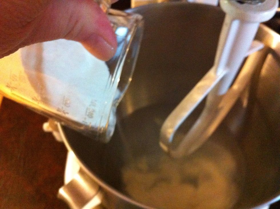 Pour dry milk into the warm water.