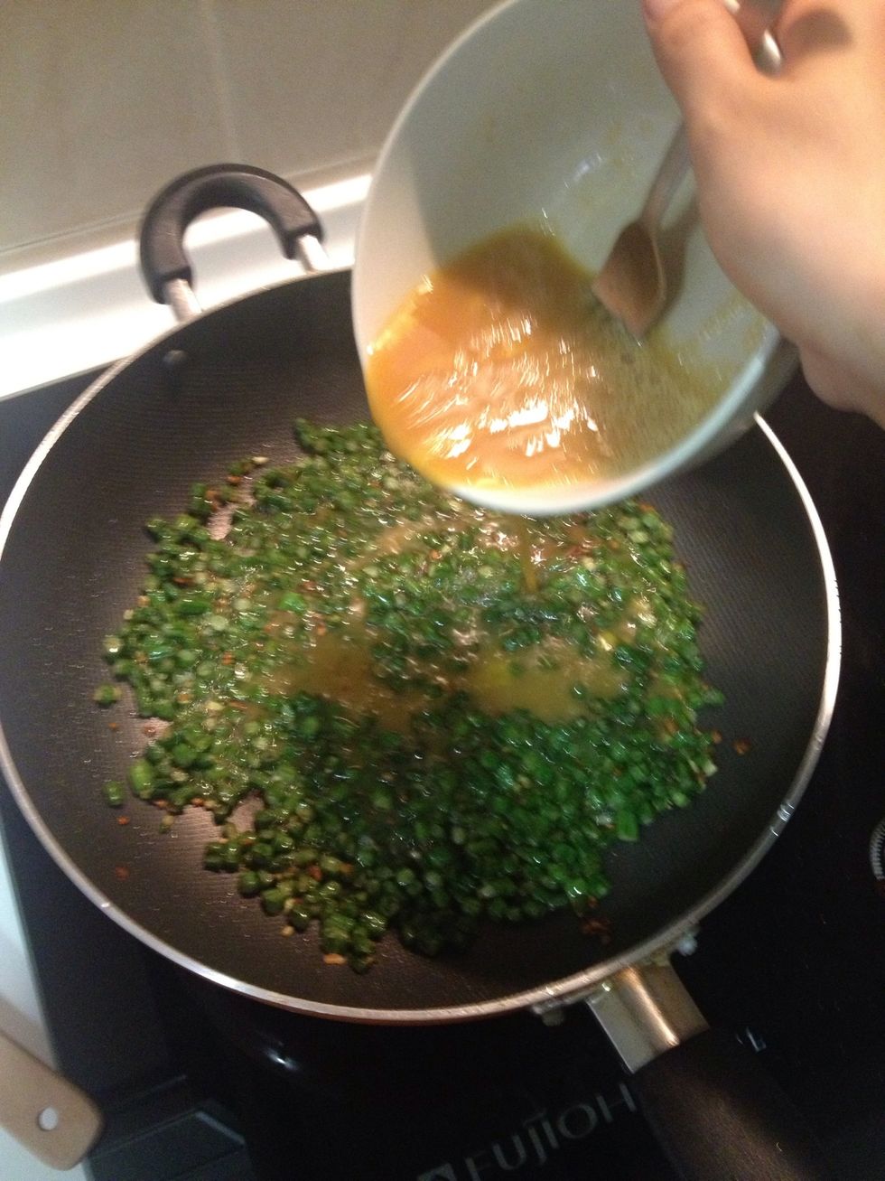 Pour egg mixture over the beans. Gently tilt the pan to ensure all beans are well coated in the egg.