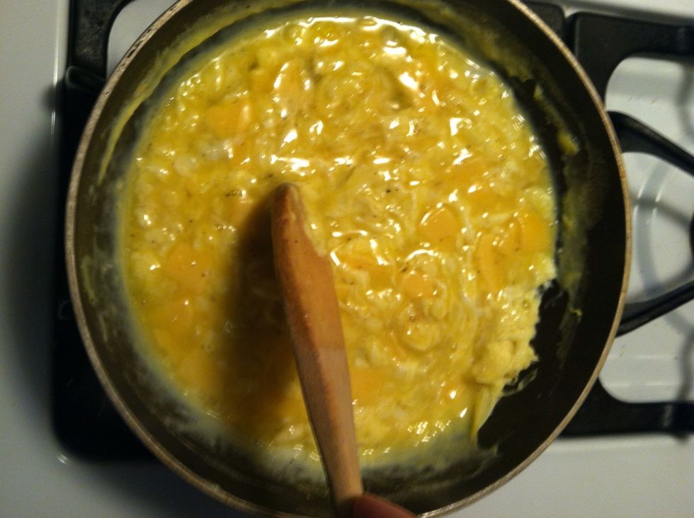 Pour eggs into a skillet on medium-low setting (make sure not to put heat up too high...you can even start on low and once in the skillet move heat up) CONSTANTLY STIR with a wooden spoon