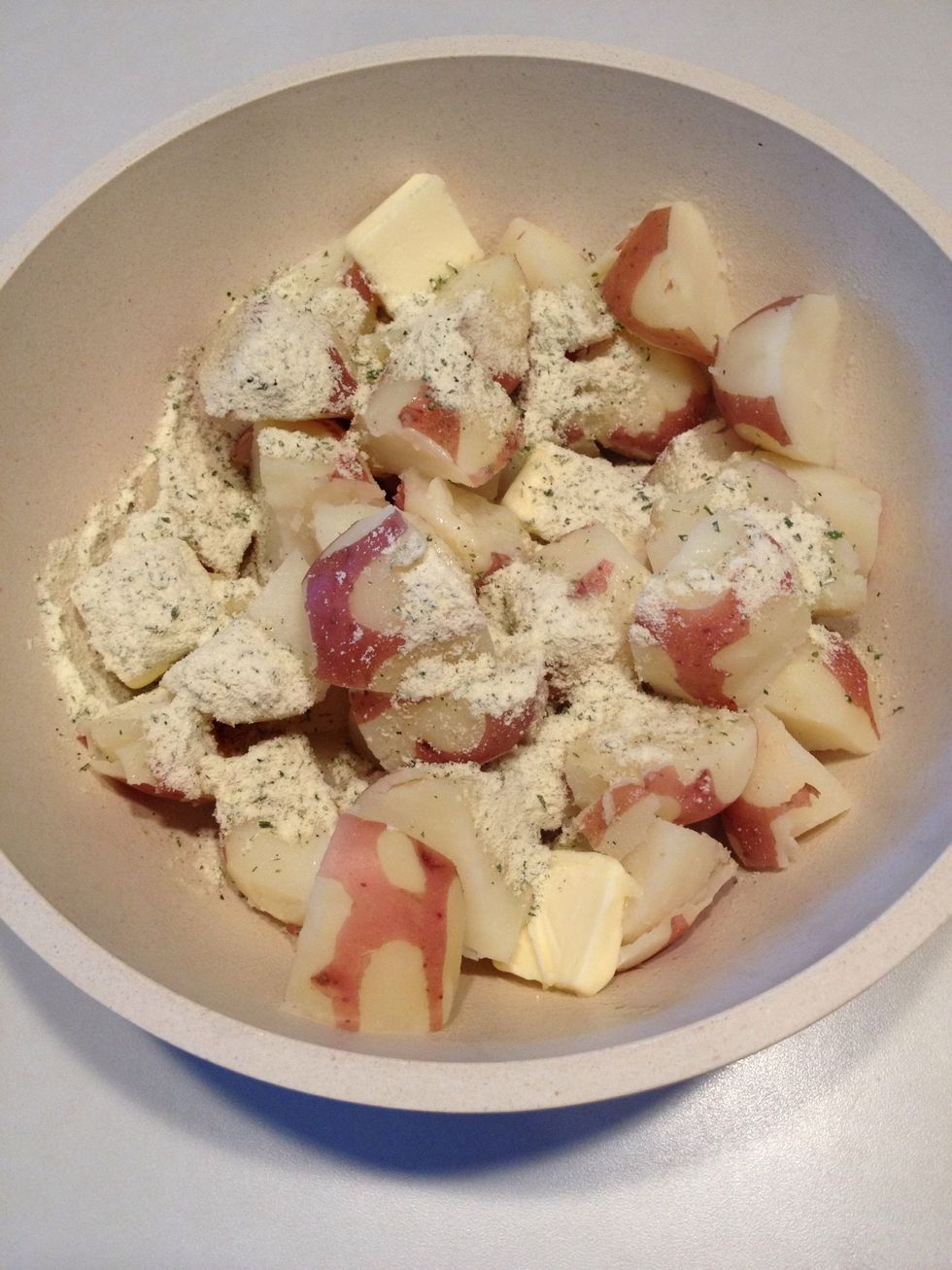 Pour entire package of dry ranch dressing over potatoes.