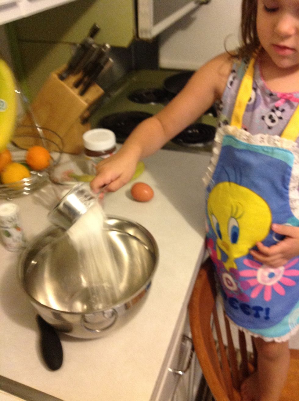 pour flour into mixing bowl. put in a pinch of salt.