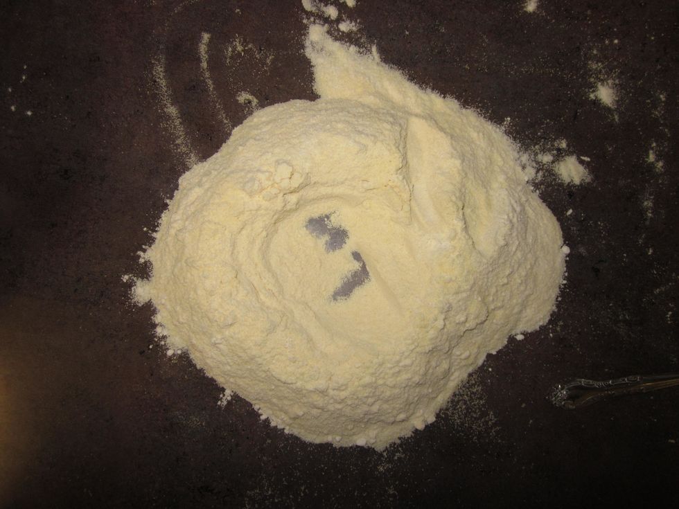 Pour flour out onto the counter and make a well in the center