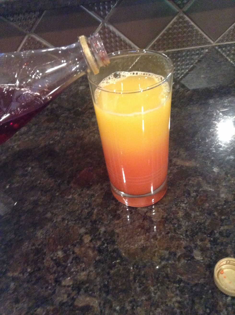 Pour grenadine in and let it sink to the bottom.