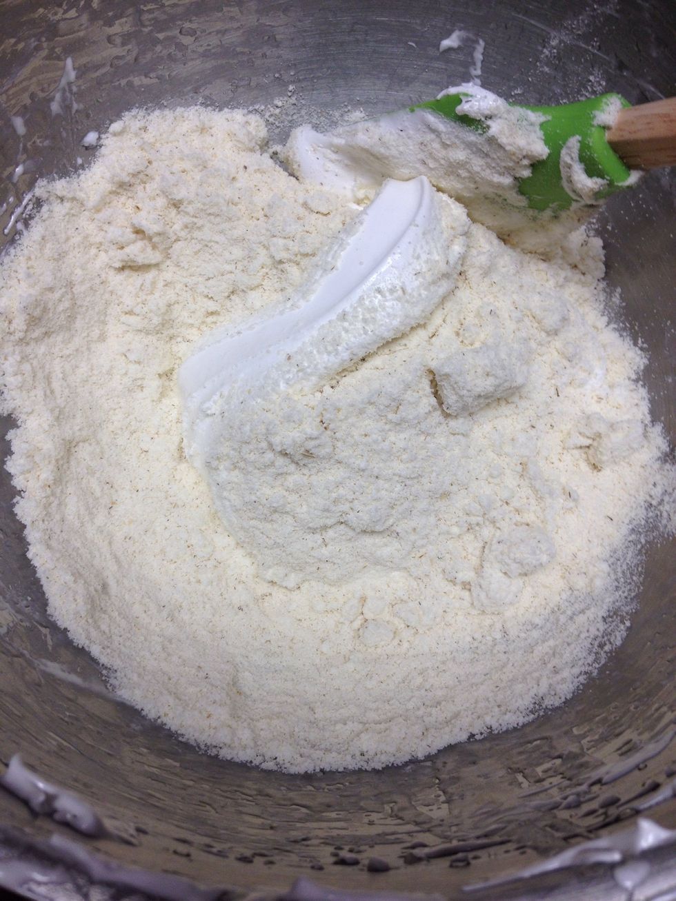 Pour half of the almond mix into the egg whites and fold in