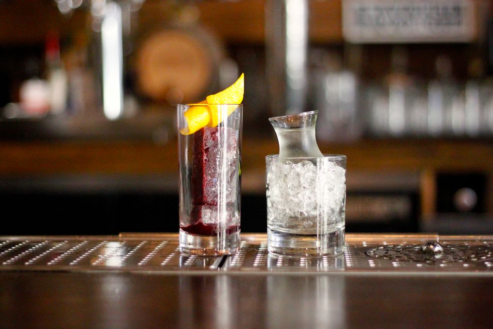 Pour half of the contents of the sidecar onto the port ice. Watch the drink get it's namesake chameleon-like coloring as the drink changes from clear to garnet as the port ice melts.