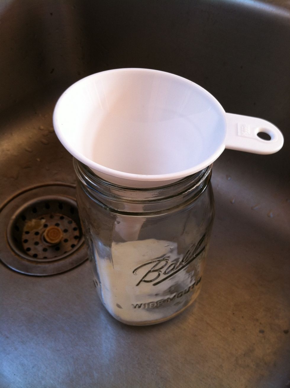Pour heated milk into jars and cap.