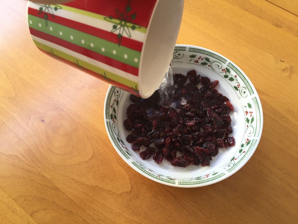 Pour hot water over dried cranberries. Let sit for 10 minutes, then drain and set aside.