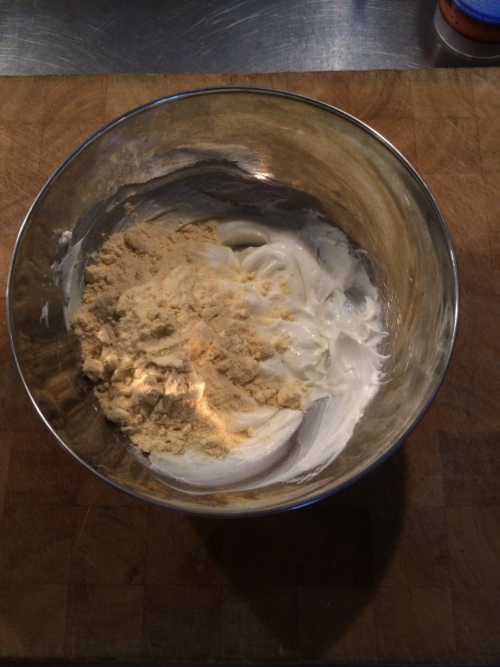 Pour in a can of cream cheese and 2 cups vanilla protein powder and stir well.