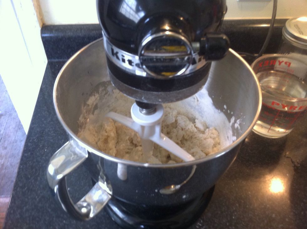 Pour in about 75% of the flour and all the yeast into the mixing bowl. DO NOT ADD ALL THE FLOUR AT THIS TIME! I usually start out with the paddle and later switch to the dough hook.