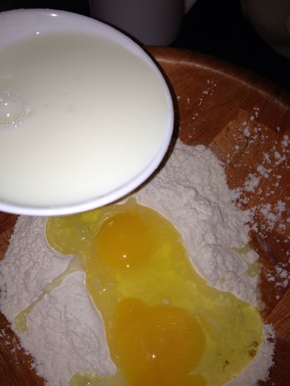 Pour in flour, then 1 1/2 cup milk into mixture