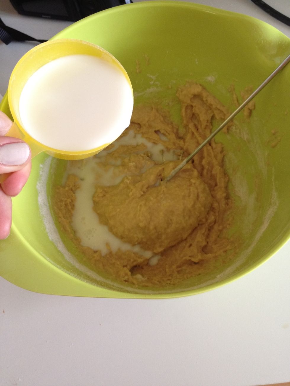 Pour in half of the milk and whisk into a lump free smooth cream. Some lumps are okay...