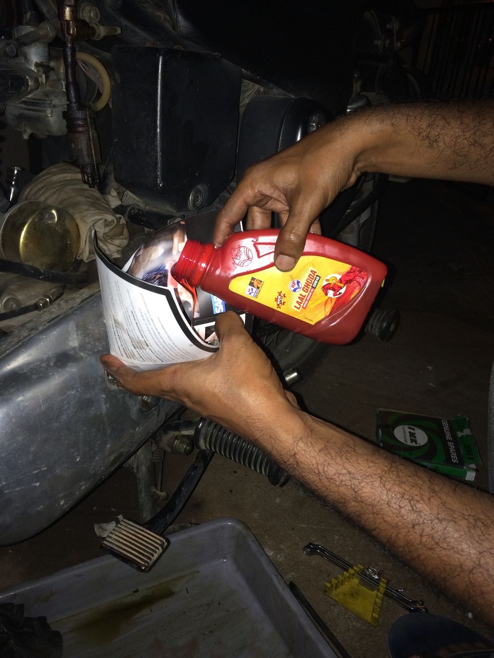 Pour in new oil until oil starts dripping from the bottom drain level screw hole