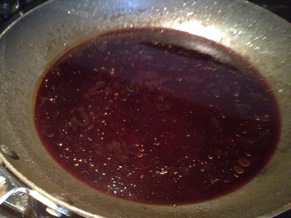 Pour in red wine and mix with lamb juices in pan.