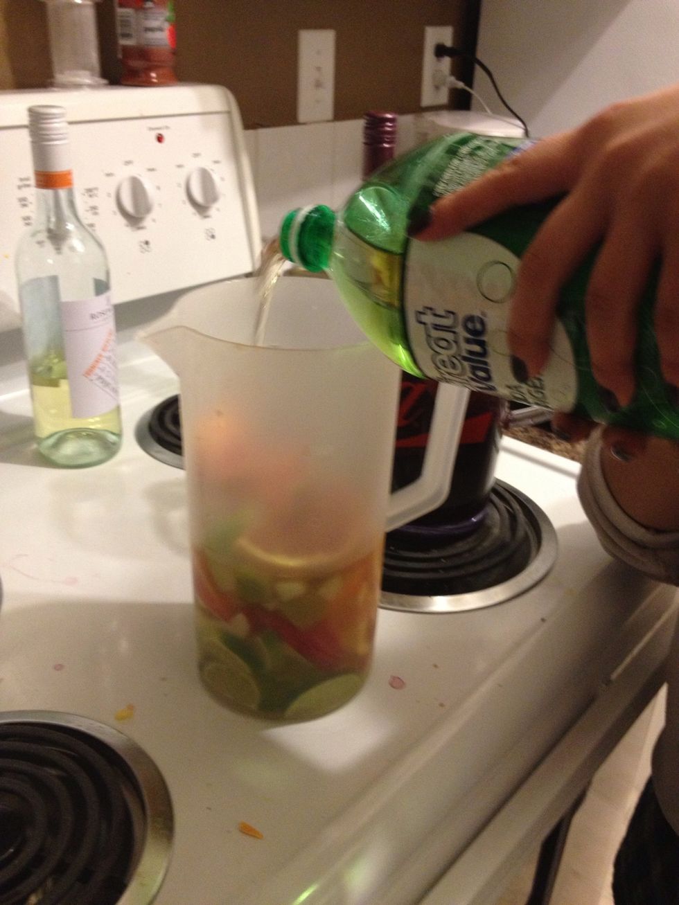 Pour in the ginger ale into the pitchers until its full.